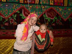 08 Yilik Headman Daughter And Her Child In A Swing In Their Sleeping Area On The Way To K2 China Trek